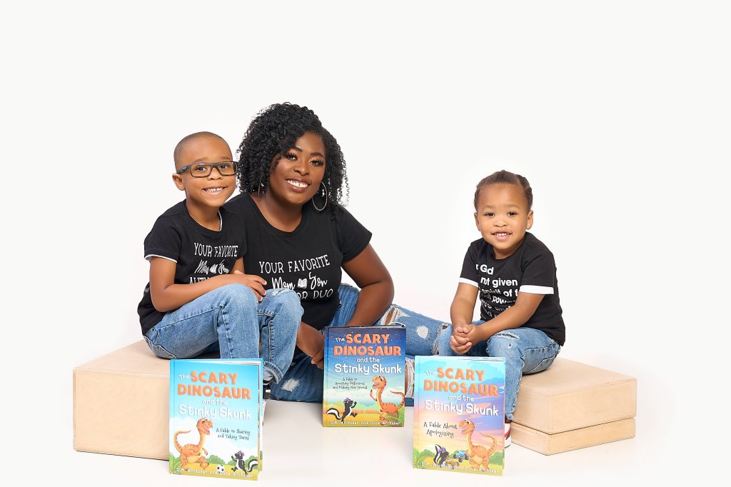 Da'Quisha Whitaker and her sons with the Scary Dinosaur and Stinky Skunk Series books